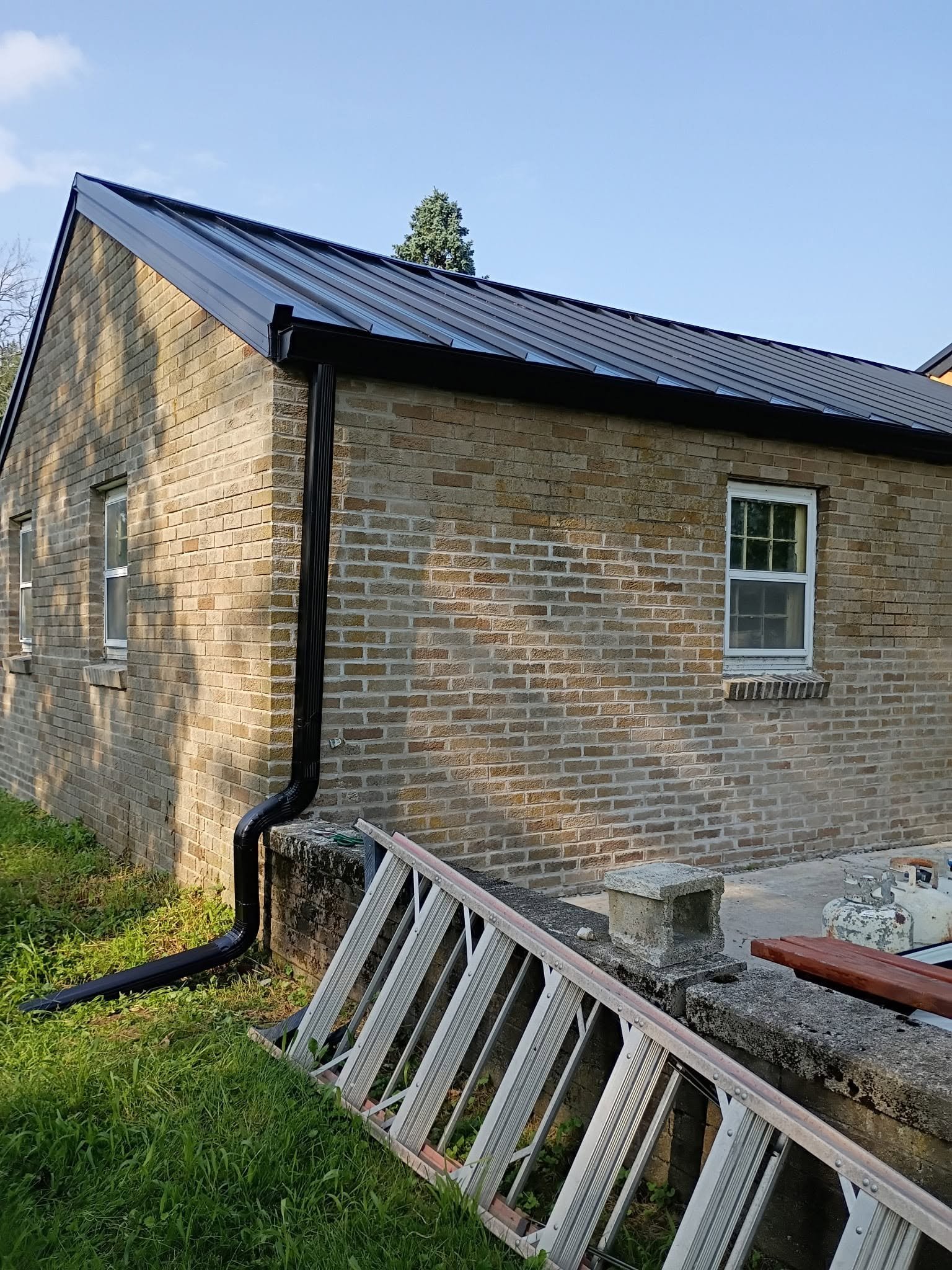 Black standing seam metal roof installed by Cox Roofing